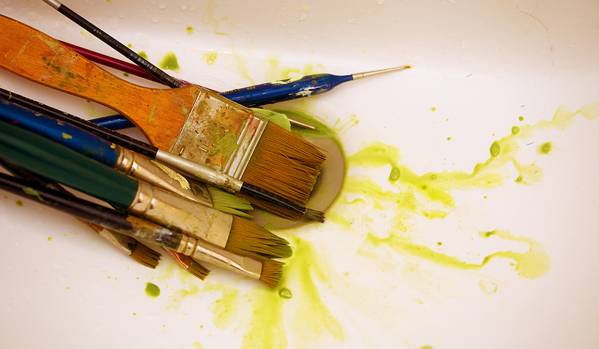 Image of paint brushes in a sink